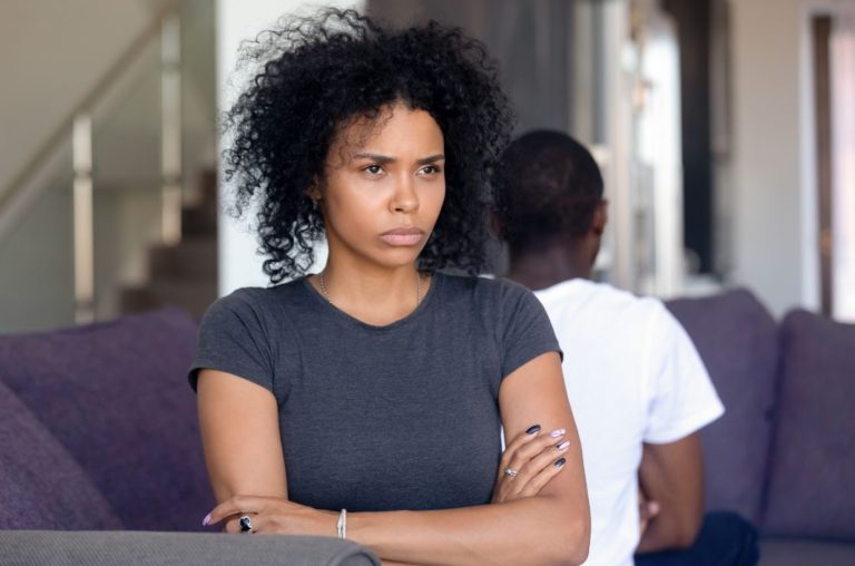 Couple giving each other the silent treatment after a fight, highlighting conflict resolution in Strengths-Based Couples